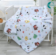 Baby crib with colorful bedding featuring cartoon animals and the brand 'Naruve' visible.